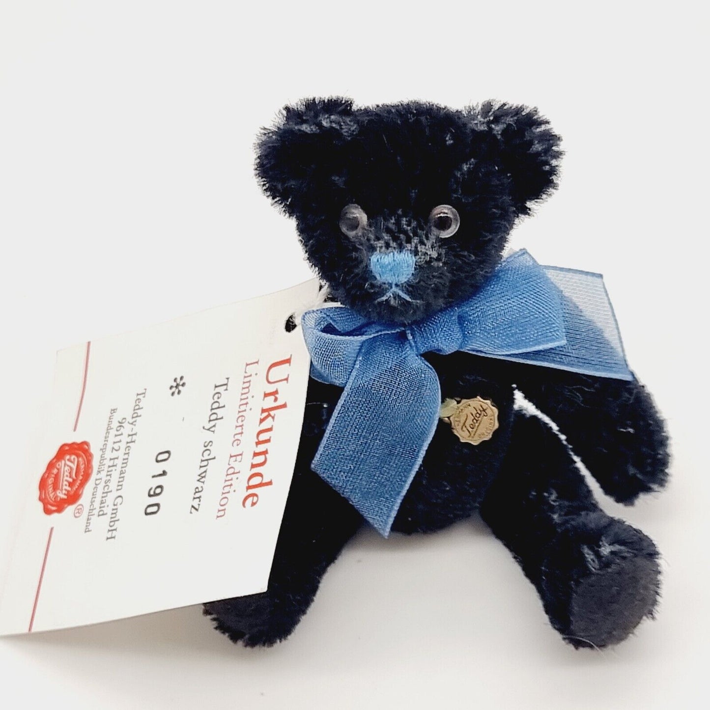 Hermann Teddy Miniatur 10 cm schwarz mit blauer Schleife Nr. 0190